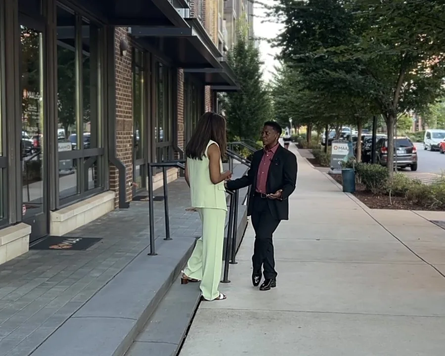 Sheri on the sidewalk, mid-conversation with Shelia Brewington